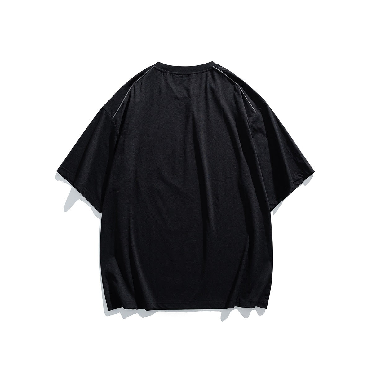 Back view of black short-sleeve crew-neck T-shirt with dropped shoulders and piping at the shoulder seams