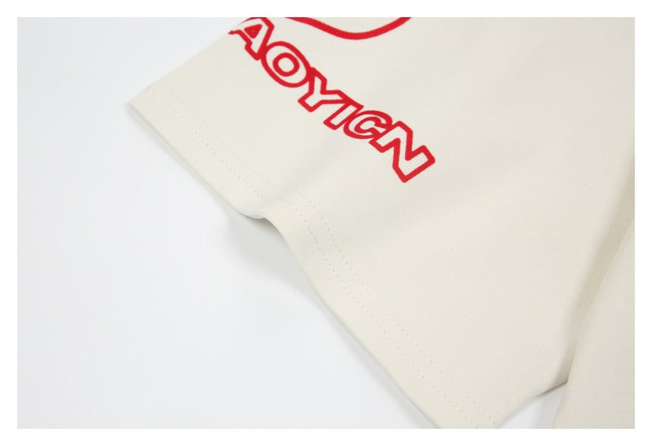 Close-up of an off-white garment hem with red outlined lettering printed above the stitching.