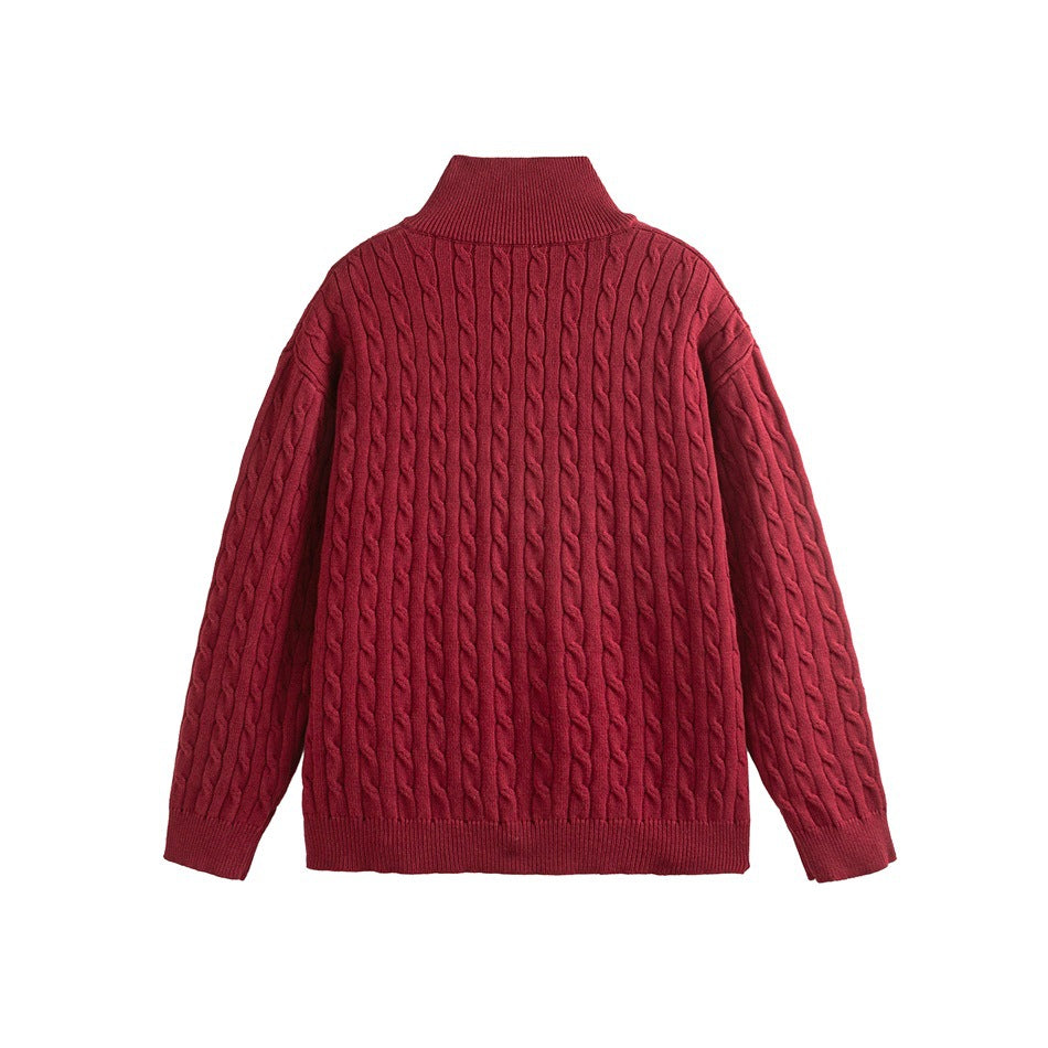 Back view of a burgundy cable-knit sweater with a high collar and ribbed cuffs and hem.