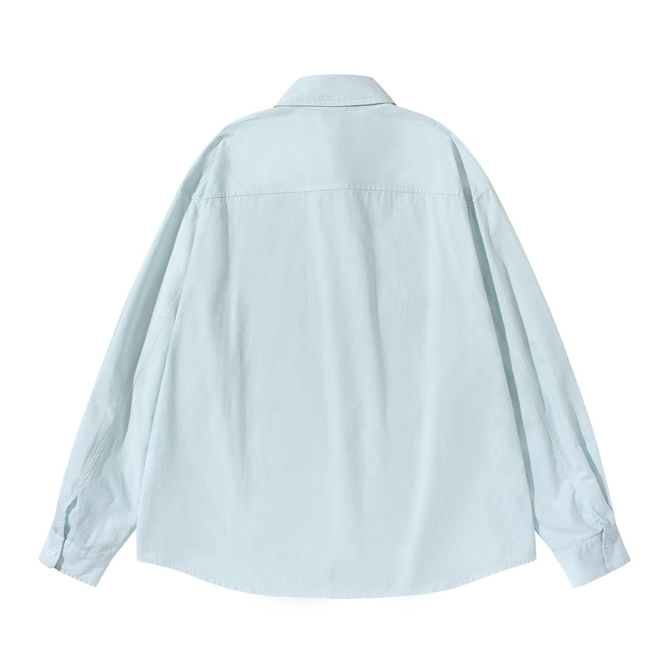 Back view of a pale mint long-sleeve button-up shirt with a yoke seam and button cuffs.