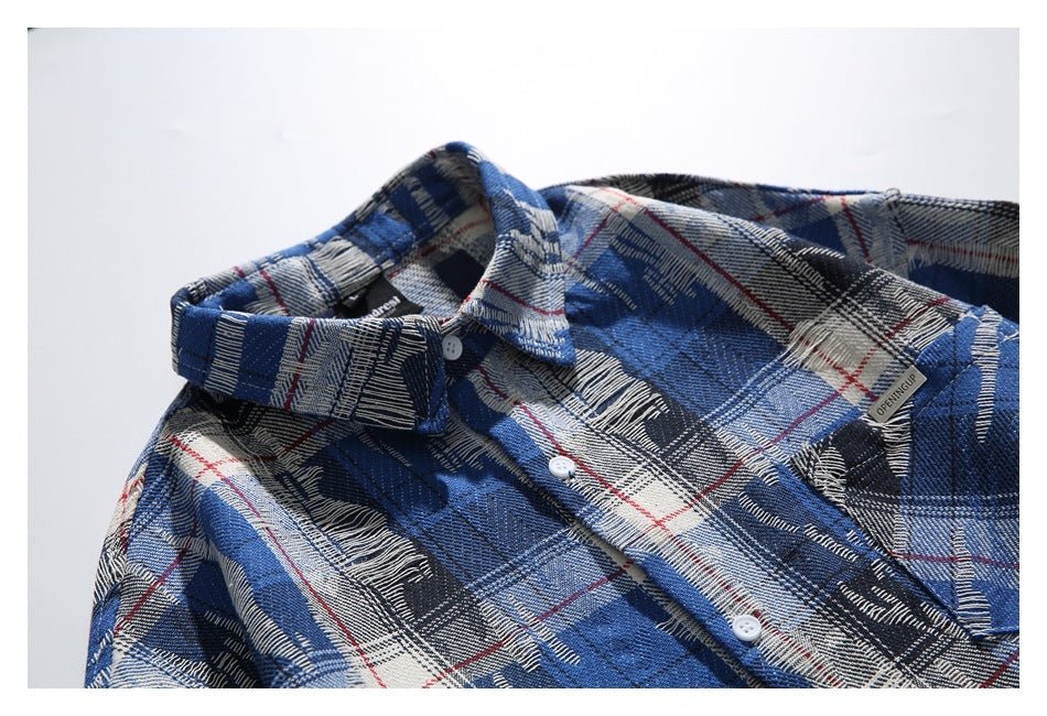 Close-up of the blue plaid shirt's collar, buttons, chest pocket, and small English label.
