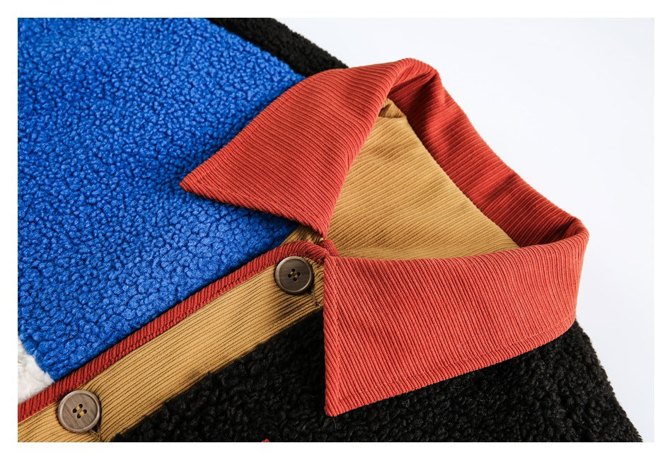 Close-up of a color-block fleece jacket collar with rust ribbed trim, tan button placket, and blue and black panels.