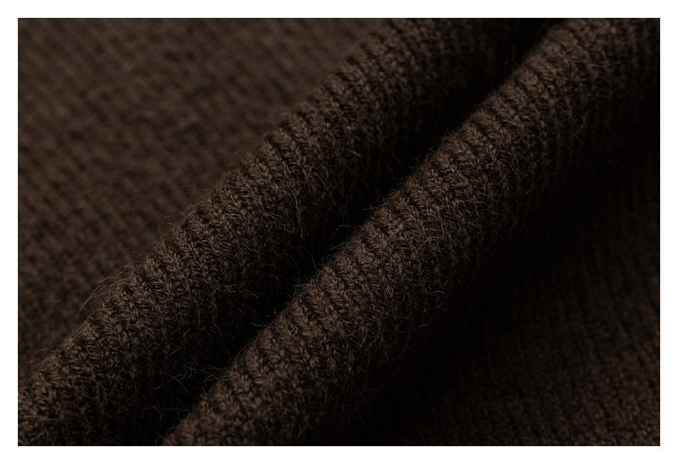 Macro view of the brown knit garment's folded, textured edge.