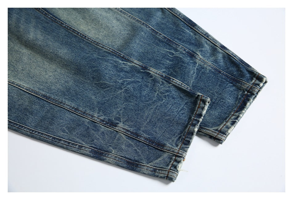 Close-up of two faded blue jean legs with straight hems and visible contrast stitching.