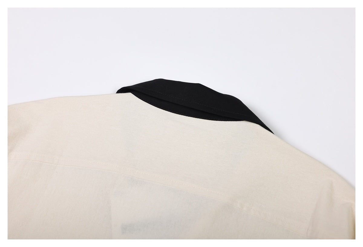 Close-up of the cream garment's back shoulder and black collar.