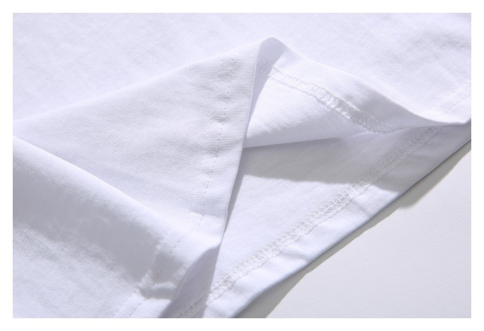 Close-up of the white T-shirt hem and overlock stitching.