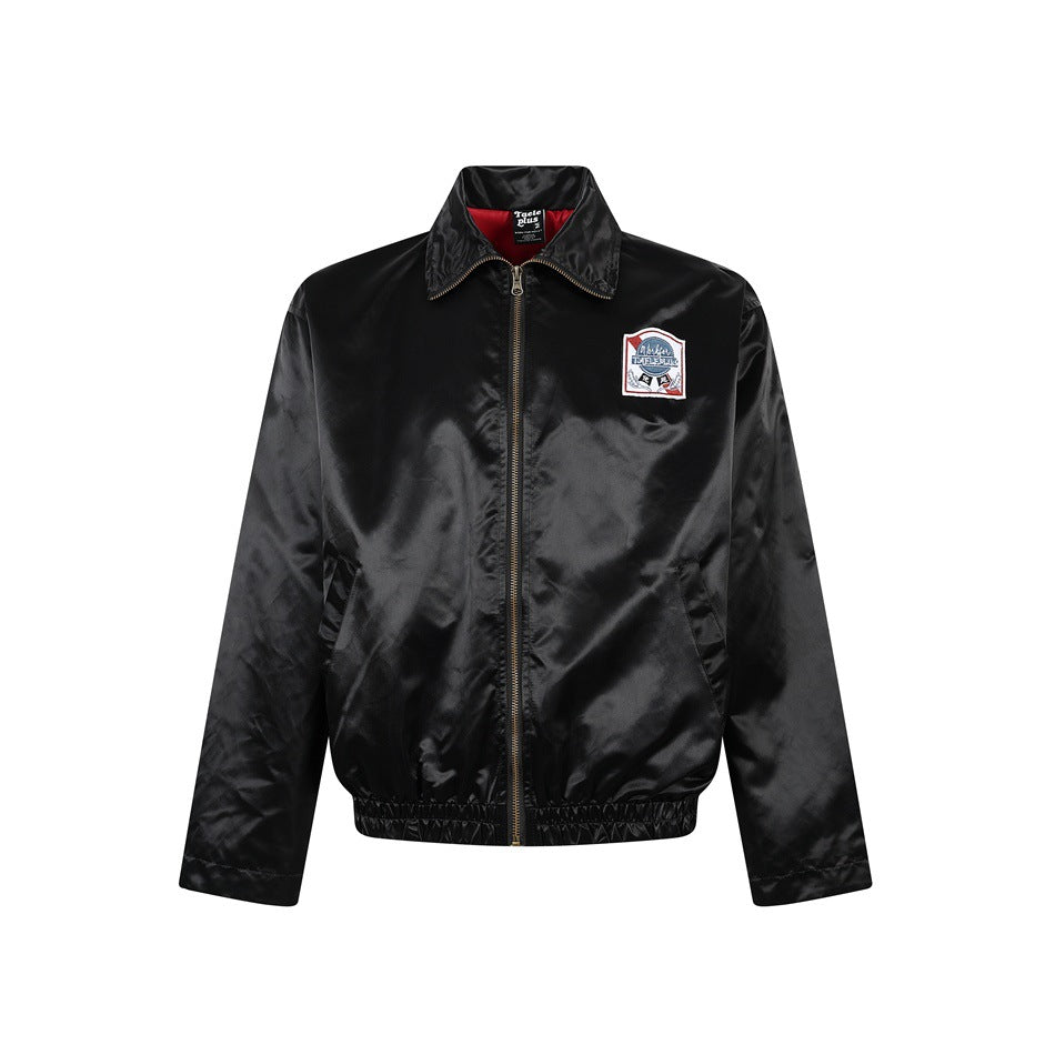 Black satin-finish zip jacket with collar, slanted pockets, elastic hem and chest patch, front view