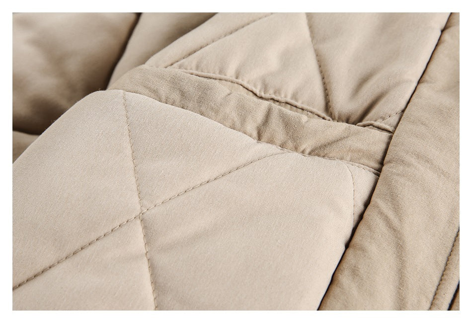 Close-up of beige quilted garment panels with visible stitched seams.