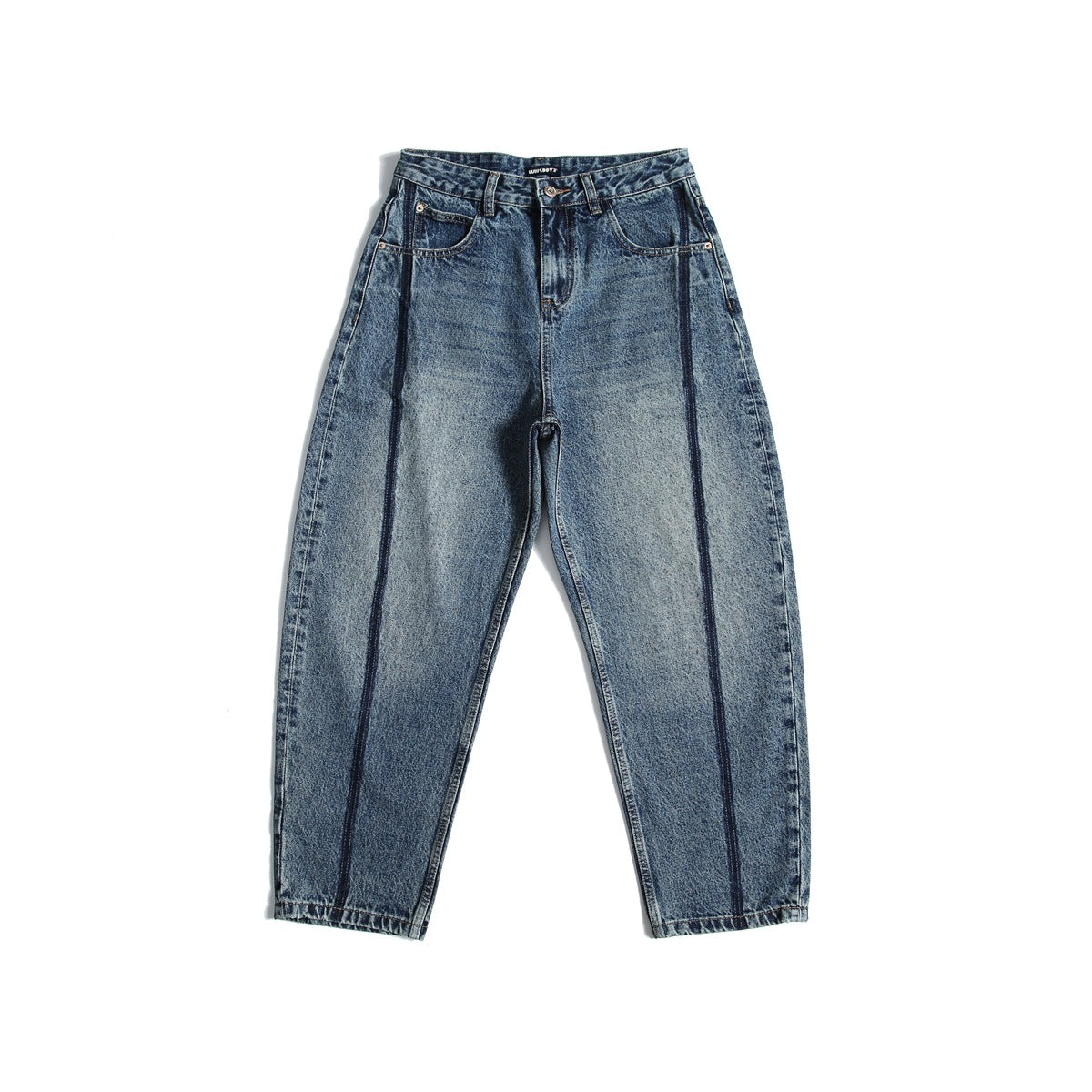 Flat lay of washed blue tapered jeans with dark contrast vertical seams on each leg, front view