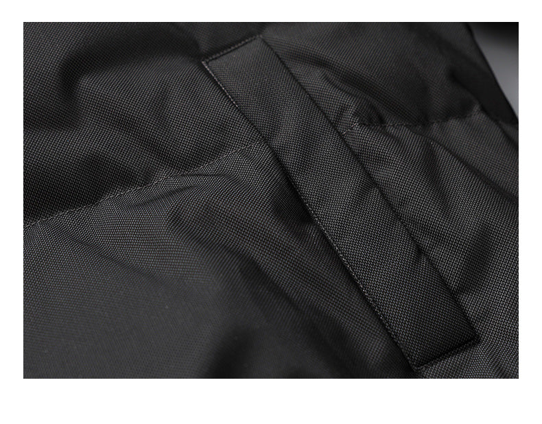 Close-up of a wide stitched strap crossing a black garment panel.