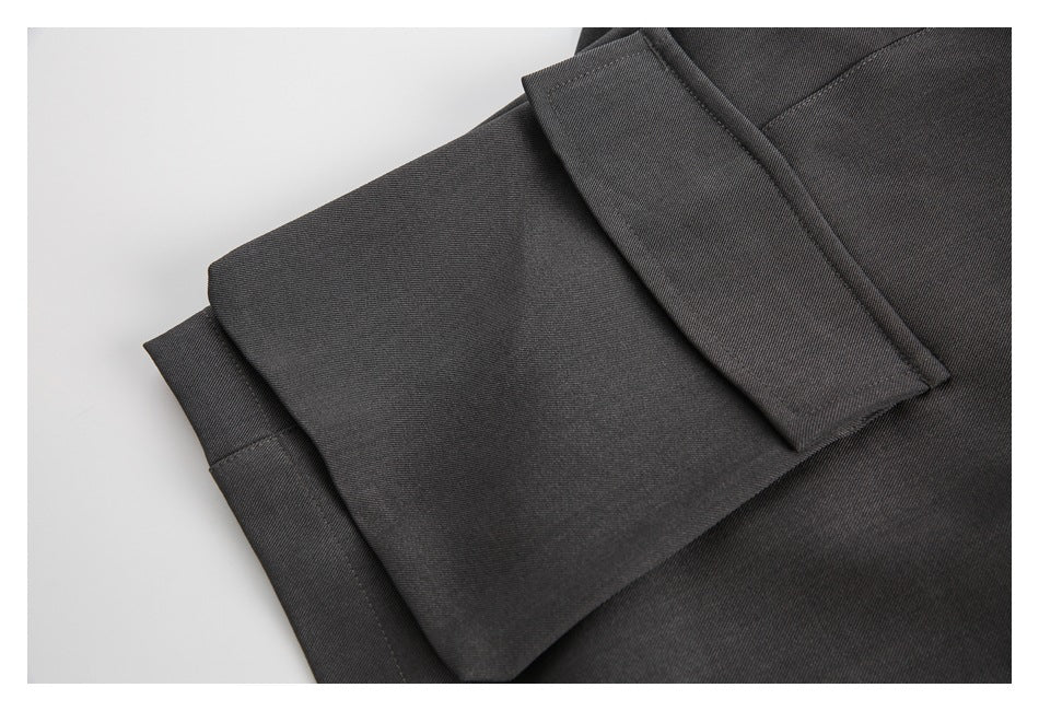 Close-up of a charcoal garment with a folded, stitched edge.