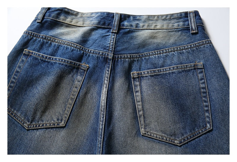 Back view of blue faded jeans showing the waistband, center seam, and two patch pockets.
