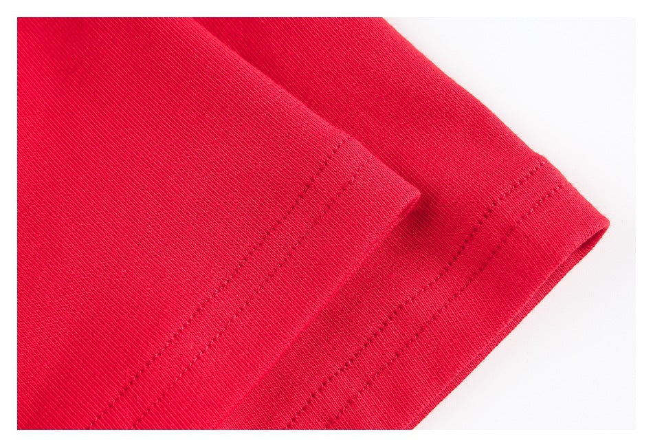 Close-up of the double-stitched hem on a red garment.