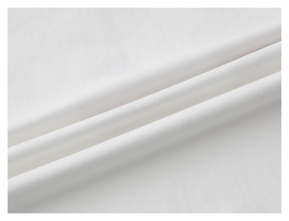 Close-up of white T-shirt fabric arranged in soft folds.