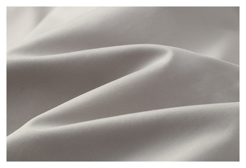 Close-up of softly folded light gray fabric with a fine, subtly textured surface.