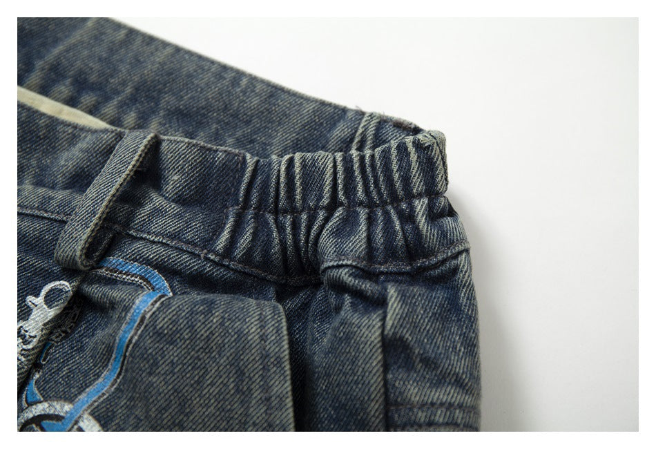 Close-up of the jeans' gathered elastic waistband and belt loop.
