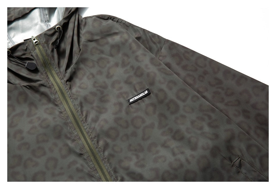 Close-up of the jacket's patterned chest and sleeve, front zipper, and small black chest label.