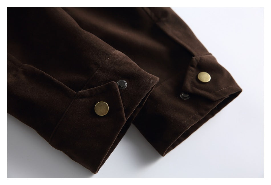 Close-up of dark brown garment cuffs with brass-tone snap buttons and black snap fasteners.