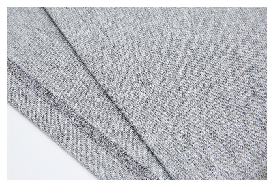 Close-up of the gray garment's interior overlocked seam and stitching.