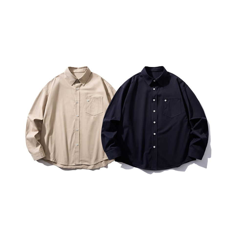 Two button-up shirts shown from the front, one beige and one dark navy, each with a chest pocket.