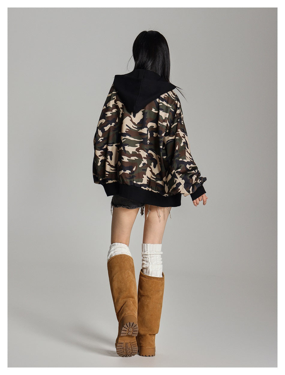 Rear view of a model wearing a camouflage jacket with a black hood, cuffs, and hem.