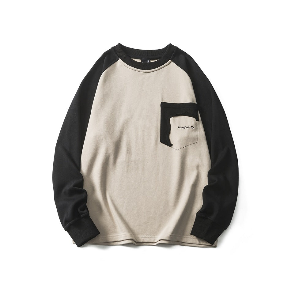 Beige crew-neck sweatshirt with black raglan sleeves, ribbed cuffs and a black-trimmed chest pocket, flat lay