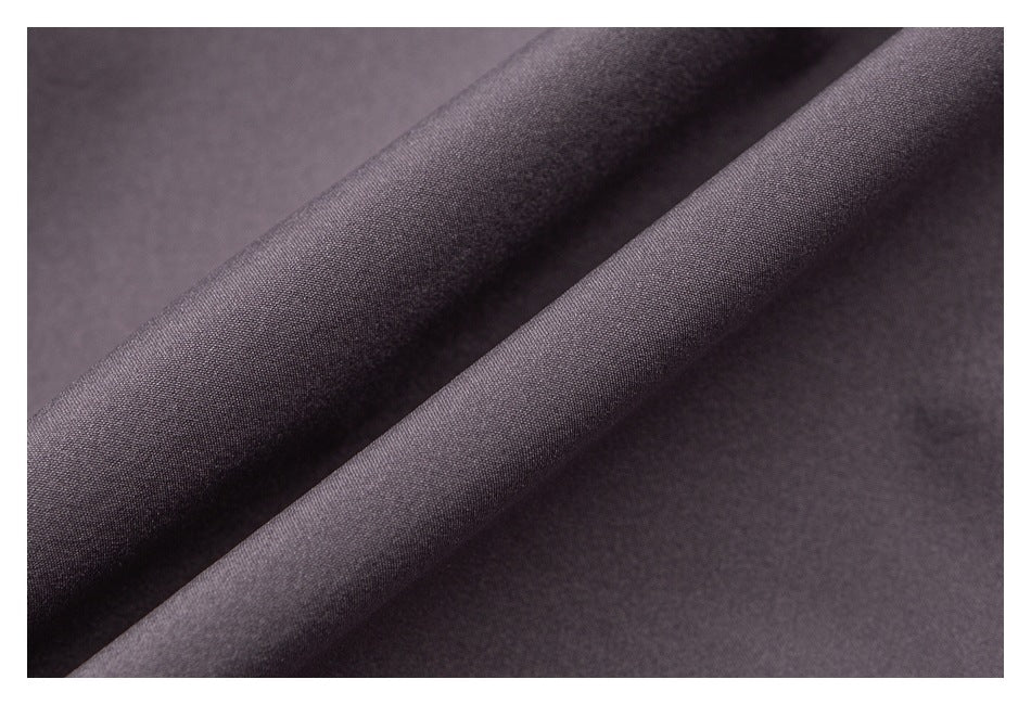 Macro view of the fine surface texture and folds of mauve-gray garment fabric.