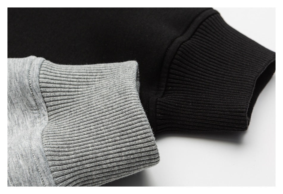 Close-up of gray and black ribbed cuffs on a heather-gray garment.