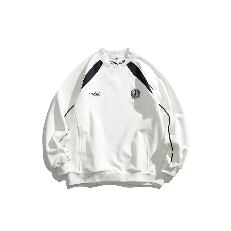 White crewneck sweatshirt with navy shoulder panels, curved sleeve piping, and small chest emblems, shown from the front.