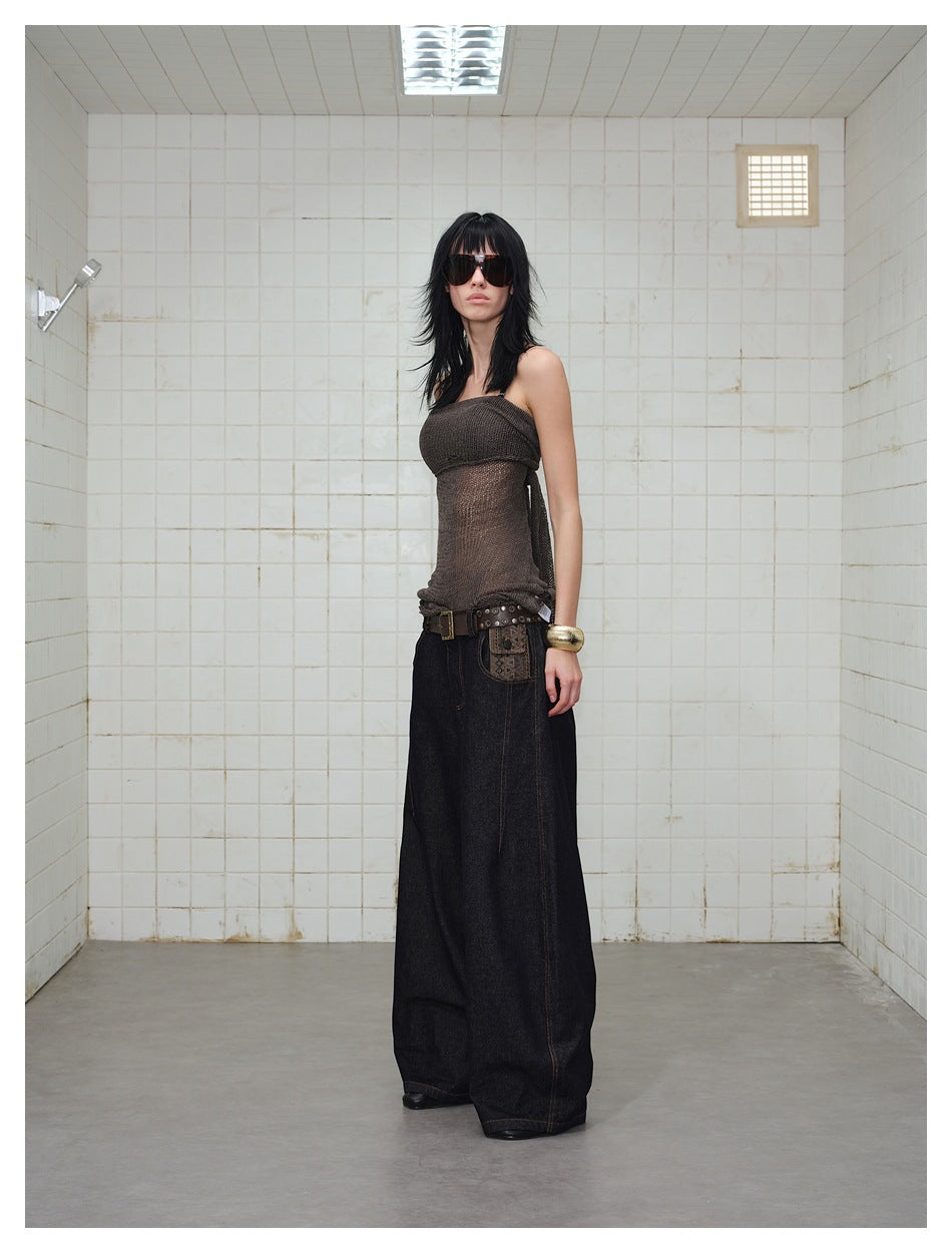 Model wearing dark wide-leg jeans with contrast stitching and a patterned pocket detail, shown at a slight angle.
