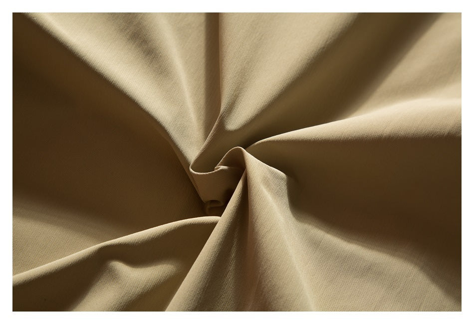 Close-up of tan fabric gathered into soft folds.
