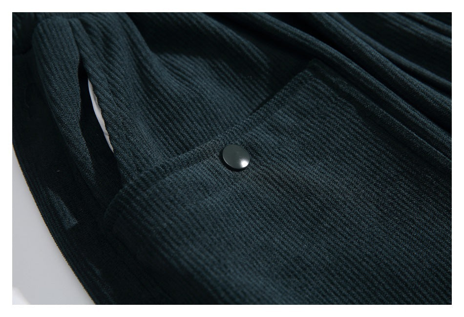 Close-up of a dark snap fastener on a ribbed pocket panel of the pants.