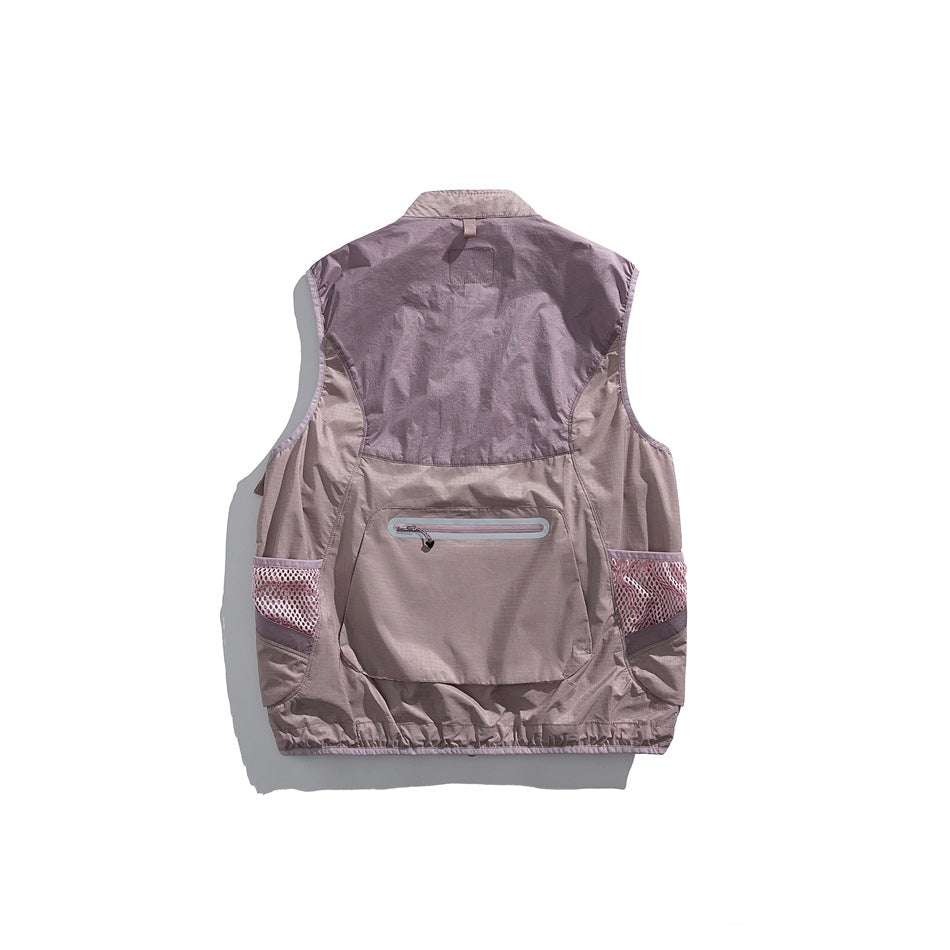 Back view of a dusty mauve utility vest with a horizontal zip pocket and mesh side pockets.