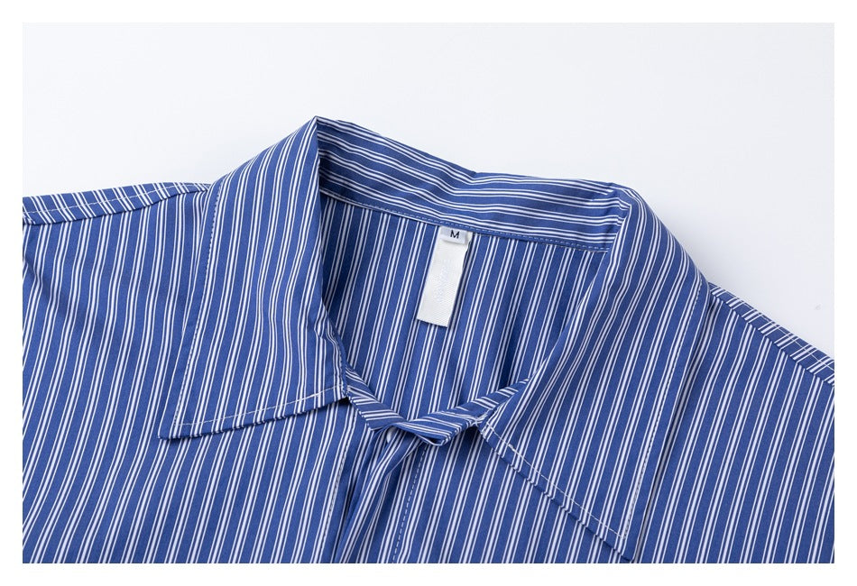 Close-up of the blue and white pinstriped shirt collar and neck label marked M.