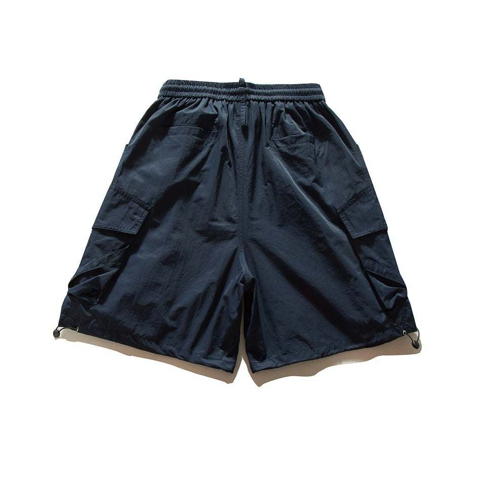 Navy cargo shorts shown from the back, with an elastic waistband, side pockets, and adjustable hem toggles.