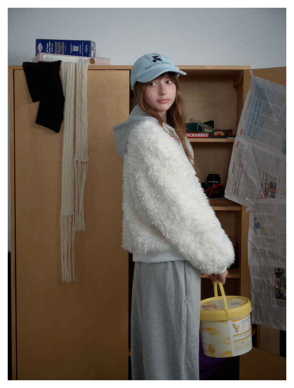 Model in a white fluffy zip jacket with a gray hood, gray pants and a pale blue cap, shown in a closet setting.