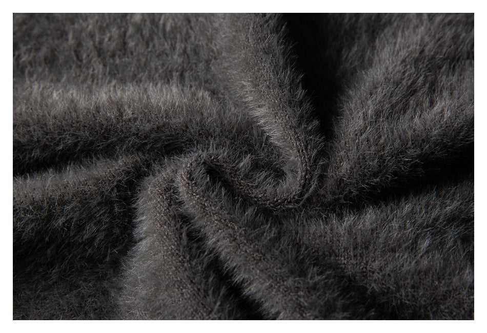 Close-up of dark charcoal-gray fabric with a dense, soft-looking fuzzy texture.