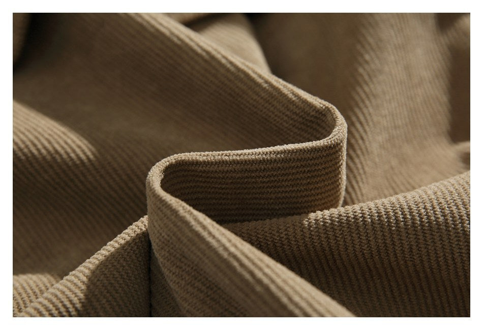Close-up of a curved edge in tan ribbed jacket fabric.