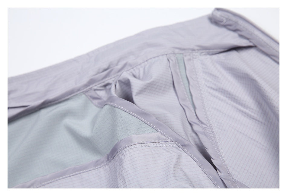 Close-up of the light gray jacket's interior lining, seams, and pocket opening.