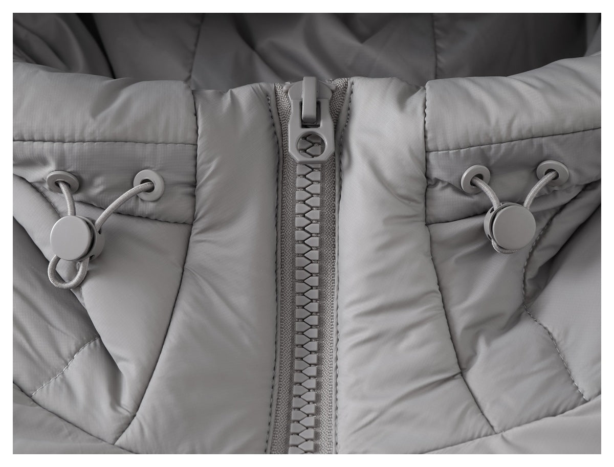 Close-up of a gray padded jacket with a chunky front zipper and adjustable cord toggles near the collar.