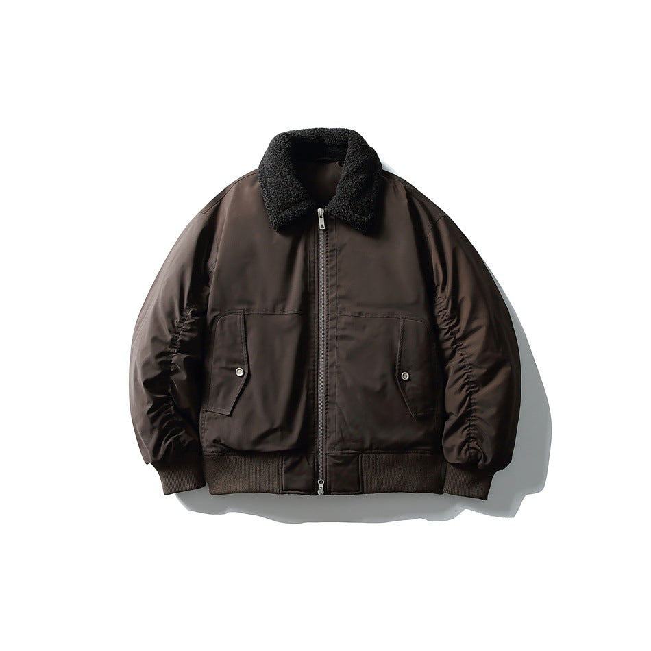 Front view of a dark brown bomber jacket with a black textured collar, zip closure, flap pockets, and ribbed trim.