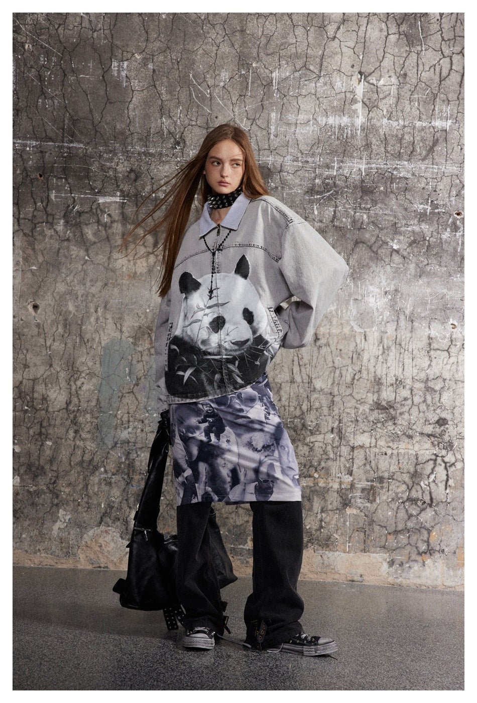 Model poses in an oversized gray panda-print jacket, a photo-collage skirt, and wide black trousers.