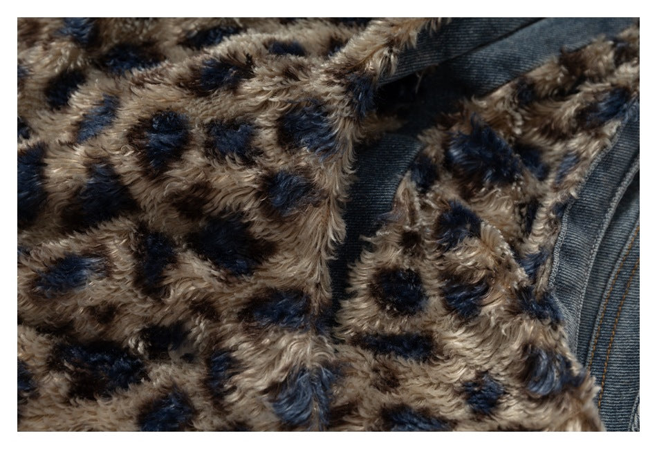Close-up showing the jacket's tan-and-navy plush panels and denim seam.