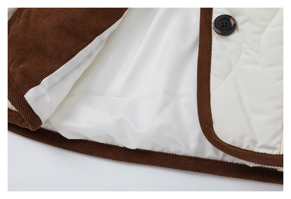 Close-up of the jacket's ivory lining, brown corduroy trim, and button fastening.