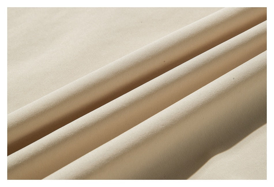Close-up showing the smooth light beige fabric draped in soft folds.