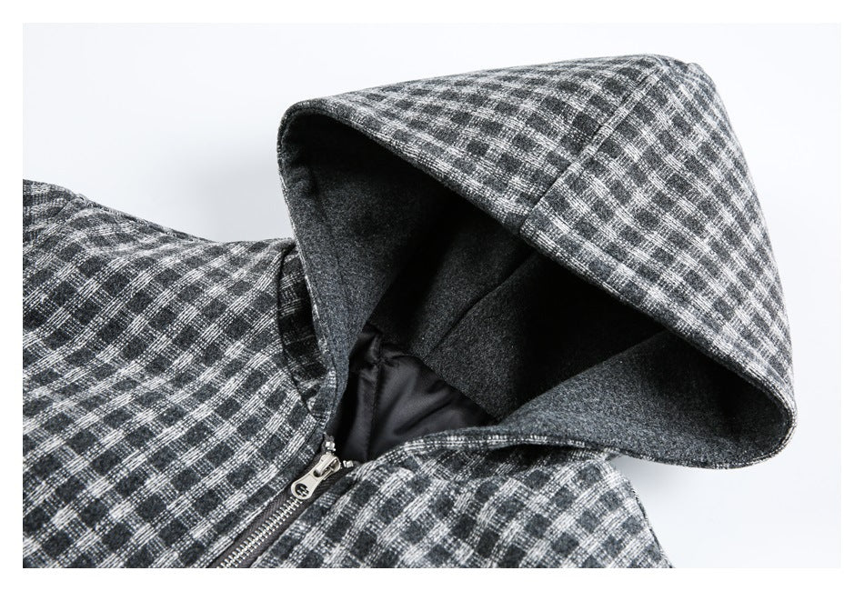 Close-up of a gray plaid jacket's hood, dark lining, and front zipper.