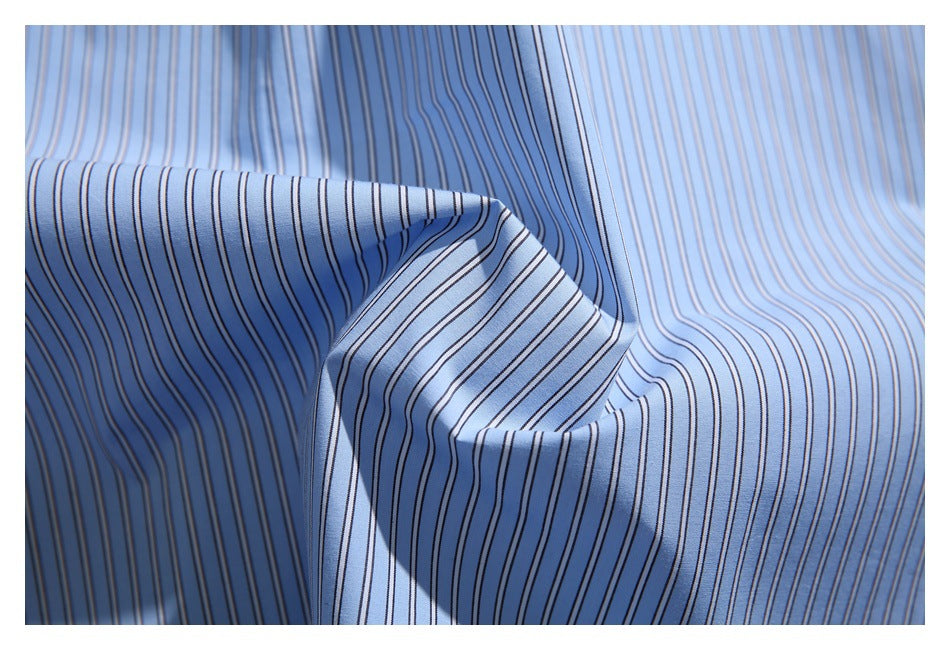 Close-up of light blue fabric with narrow dark stripes, folded to show its drape.