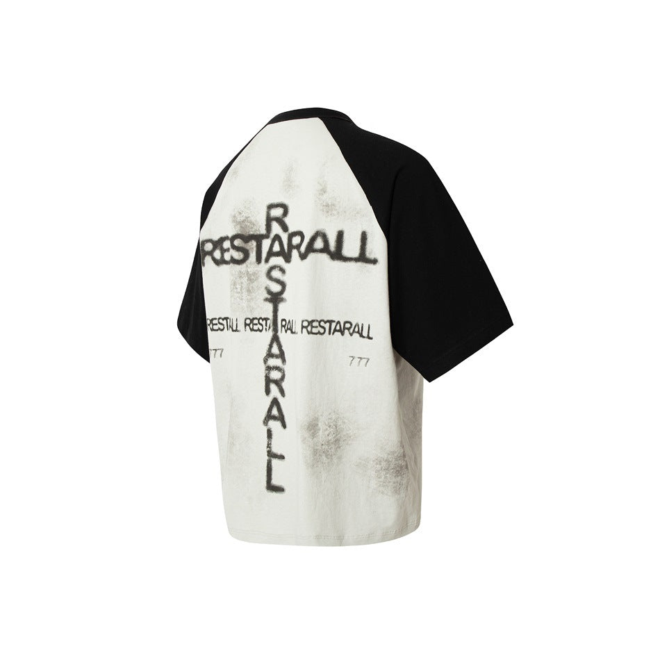 Back of an off-white raglan T-shirt with black sleeves and distressed black lettering and marks.