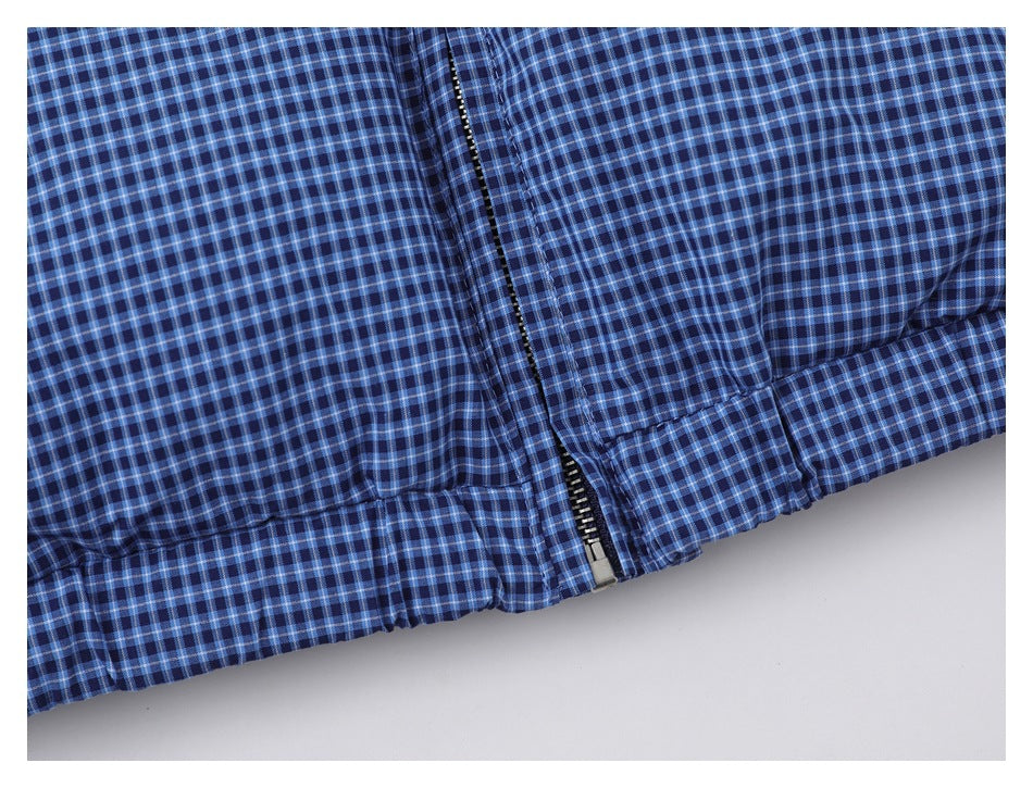 Close-up of the blue checked jacket hem and front zipper.