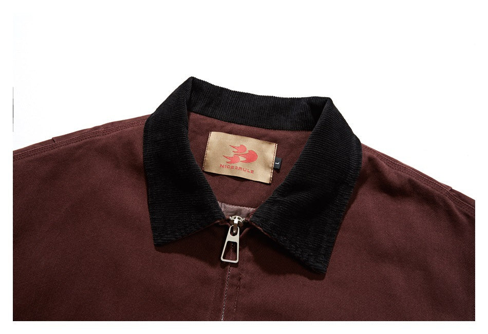 Close-up of the burgundy jacket's black collar, front zipper, and sewn-in brand label.